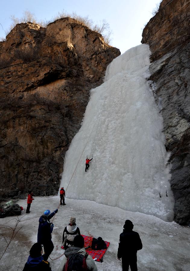 Tourists do ice climbing on a frozen waterfall in the Anjiazhuang Valley of Mentougou District, a suburb of Beijing, capital of China, Feb. 23, 2013. (Xinhua/Li Wenming) 