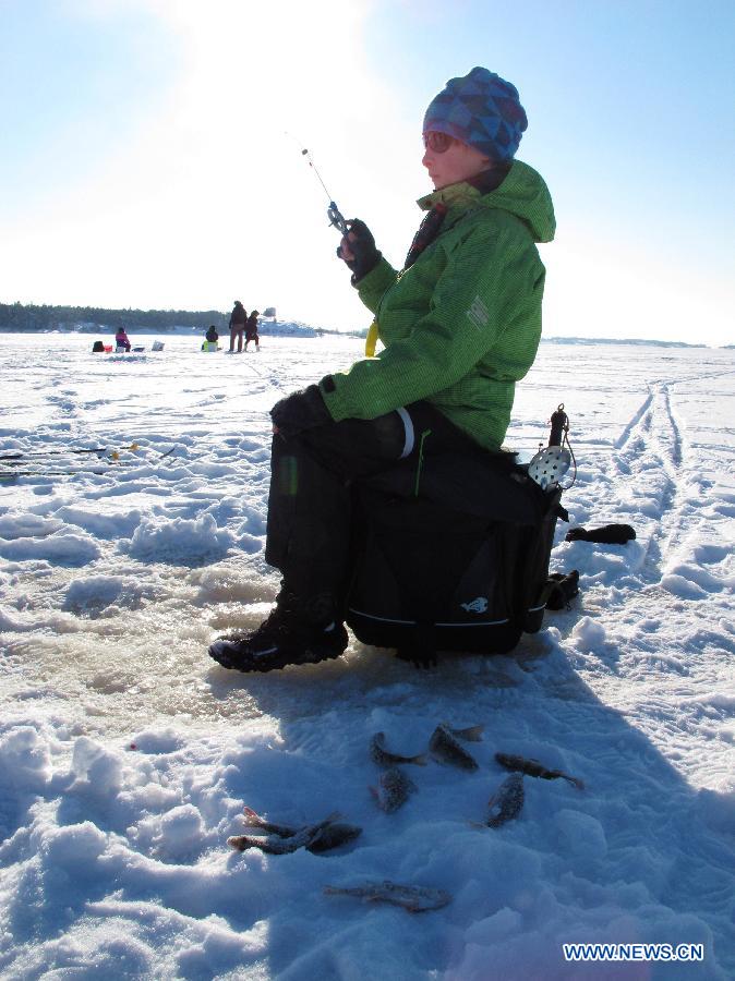 A child takes part in an ice fishing contest in Mustikkamaa, Helsinki, Finland, on Feb. 25, 2013. Winter sports are popular among children here in Finland during its long winter. (Xinhua/Zhang Xuan) 