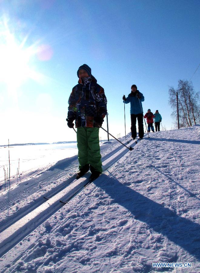 Children ski on a hillside in Mustikkamaa, Helsinki, Finland, on Feb. 25, 2013. Winter sports are popular among children here in Finland during its long winter. (Xinhua/Zhang Xuan) 