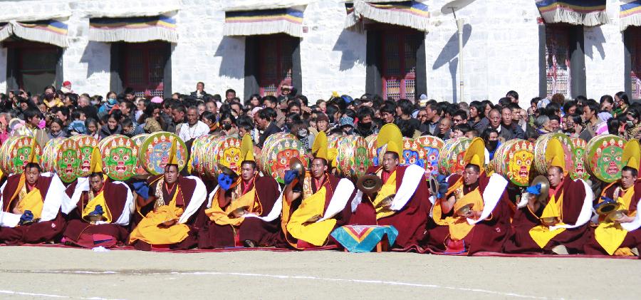 Buddhist monks offer drum and cymbal accompaniment to a ritual dance which prays for good fortune and harvest at the Labrang Monastery in Xiahe County, Gannan Tibetan Autonomous Prefecture, northwest China's Gansu Province, Feb. 23, 2013. The Labrang Monastery is among the six great monasteries of the Geluk school of Tibetan Buddhism. (Xinhua/Shi Youdong)