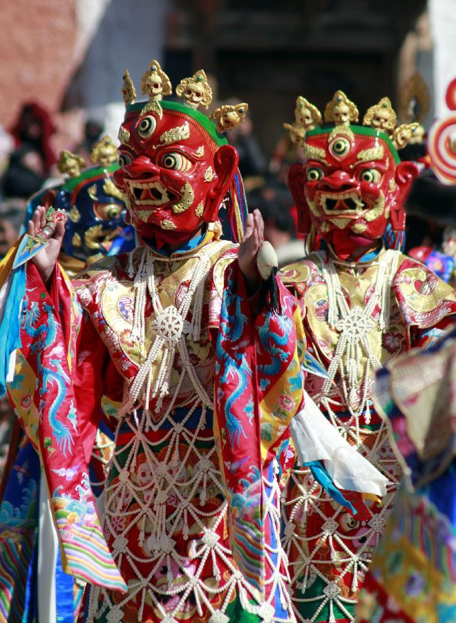 Masked Buddhist monks perform a ritual dance to pray for good fortune and harvest at the Labrang Monastery in Xiahe County, Gannan Tibetan Autonomous Prefecture, northwest China's Gansu Province, Feb. 23, 2013. The Labrang Monastery is among the six great monasteries of the Geluk school of Tibetan Buddhism. (Xinhua/Shi Youdong)