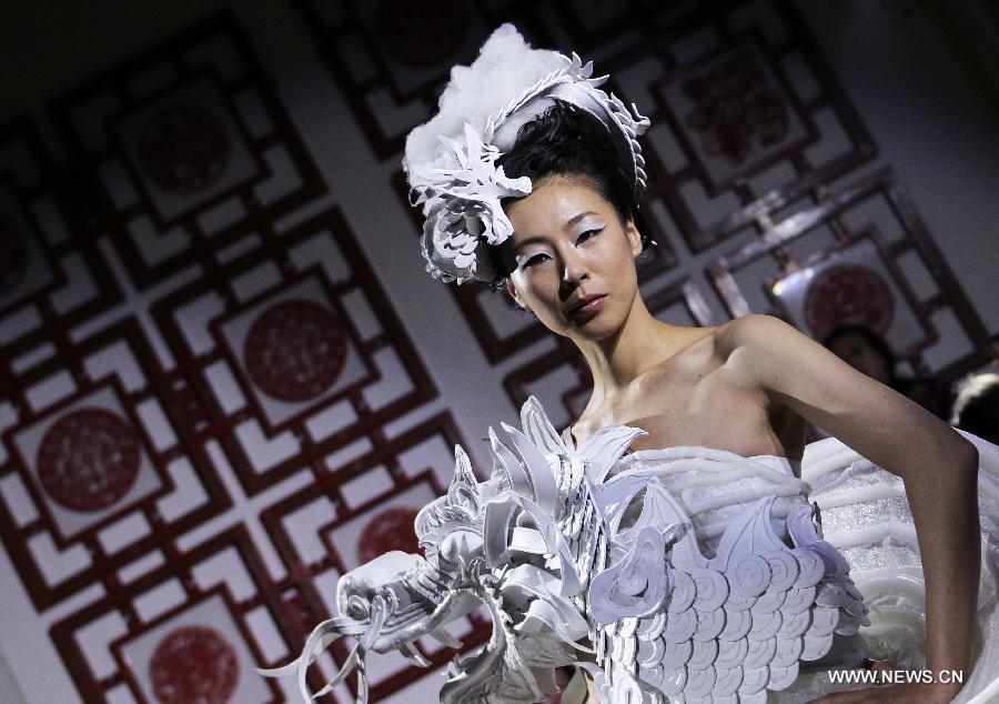 A model displays a creation by Chinese designer Xu Ming at Chinese Cultural Center in Paris, France, Feb. 25, 2013. (Xinhua/Gao Jing)