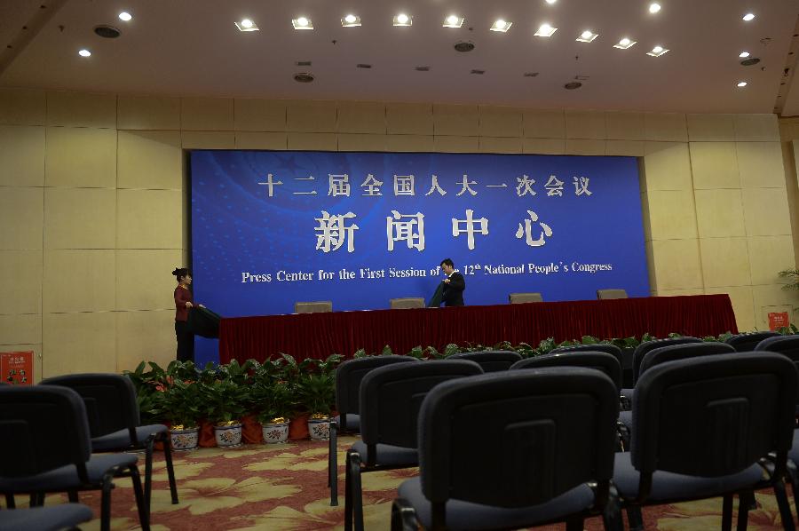 Two staff members do preparatory work in a press room of the press center for the 2013 sessions of the National People's Congress (NPC) and the Chinese People's Political Consultative Conference (CPPCC) in Beijing, capital of China, Feb. 26, 2013. The upcoming annual sessions of the NPC, China's top legislature, and the CPPCC, the country's top political advisory body, launched a press center Tuesday in the Media Center Hotel in downtown Beijing. (Xinhua/Jin Liangkuai) 