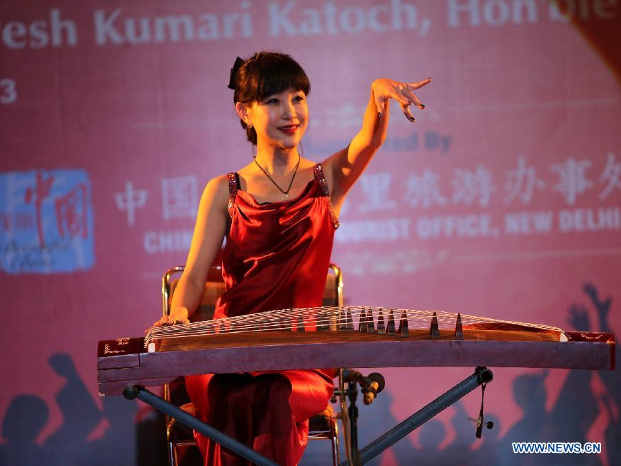A Chinese artist plays Guzheng, a traditional Chinese stringed instrument, during the "Chinese Spring Festival 2013" at FICCI Auditorium in New Delhi, India, Feb. 25, 2013. The Chinese Embassy to India and the India China Economic and Cultural Council organized the "Chinese Spring Festival 2013" Monday to showcase Chinese music, dance, and martial art. (Xinhua/Li Yigang) 