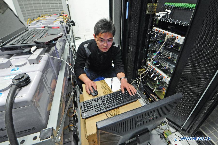 Photo taken on Feb. 23, 2013 shows an engineer working in the completing Shangyu railway station of the Hangzhou-Ningbo high-speed railway in Shangyu, east China's Zhejiang Province. Designed at a top speed of 350km/h, the 150-kilometer Hangzhou-Ningbo high-speed railway linking Hangzhou and Ningbo, two hub cities in Zhejiang, will reduce the travel time to 36 minitues when it is put into operation in July 2013, as expected. (Xinhua/Tan Jin) 