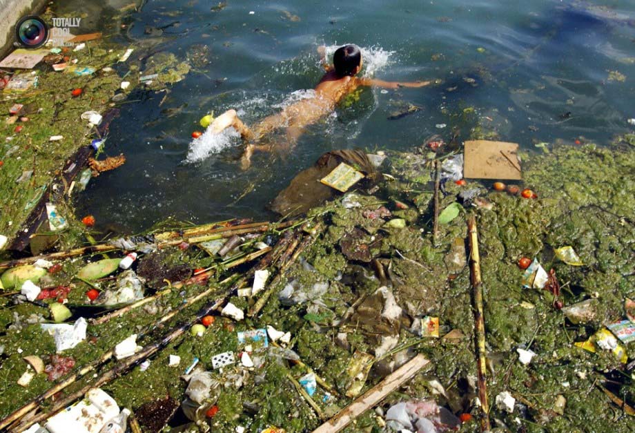 A boy swims in a severely polluted reservoir in Pingba.(File Photo)