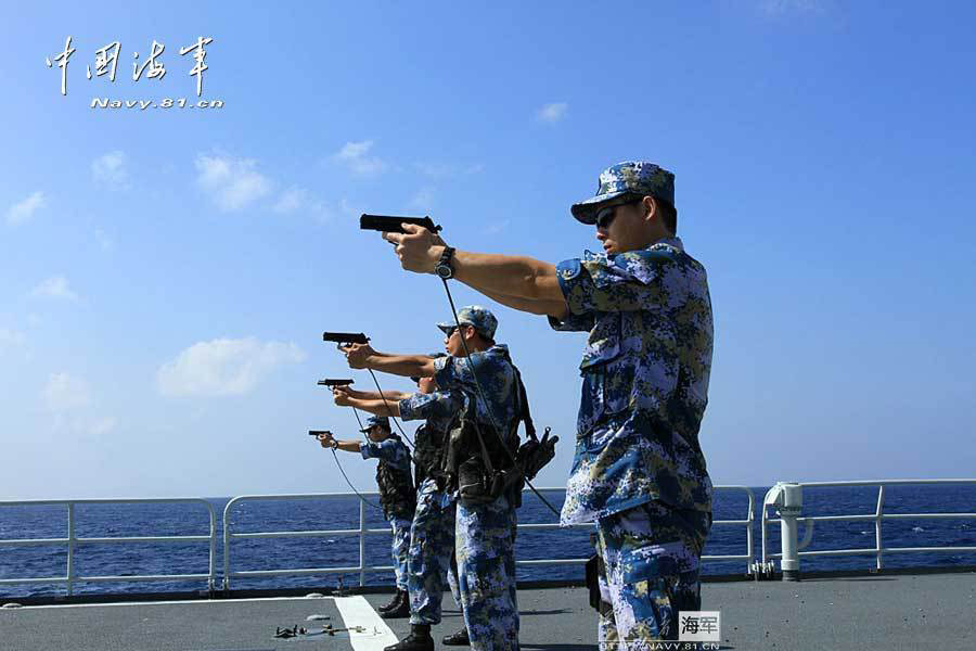 The 14th escort taskforce under the Navy of the Chinese People's Liberation Army (PLA) organizes its special operation members from the Harbin guided missile destroyer, the Mianyang guided missile frigate and the Weishan Lake comprehensive supply ship to conduct a precision shooting training with pistol and rifle on February 27, 2013. (navy.81.cn/Qin Chuan, Li Ding, Yang Qinghai)