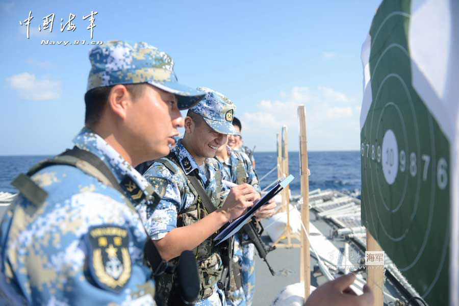 The 14th escort taskforce under the Navy of the Chinese People's Liberation Army (PLA) organizes its special operation members from the Harbin guided missile destroyer, the Mianyang guided missile frigate and the Weishan Lake comprehensive supply ship to conduct a precision shooting training with pistol and rifle on February 27, 2013. (navy.81.cn/Qin Chuan, Li Ding, Yang Qinghai)