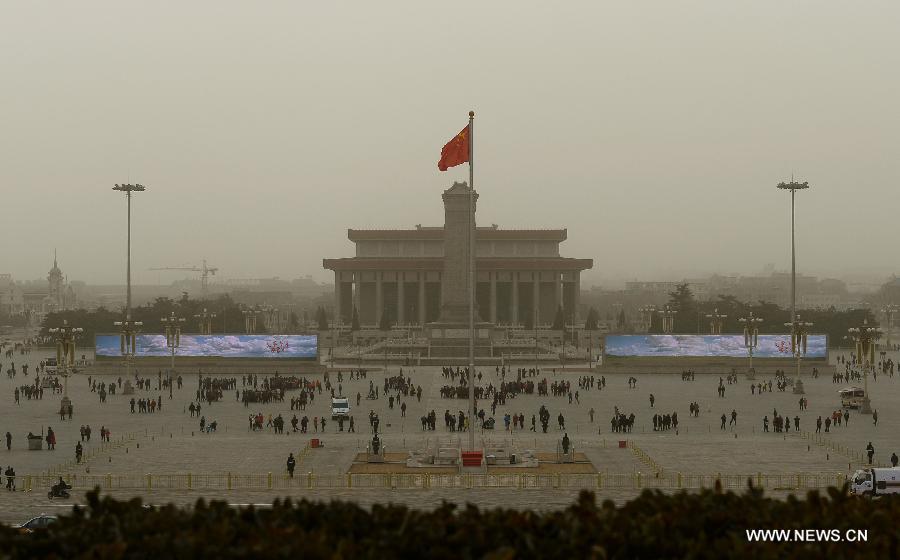 People visit the Tian'anmen Square amid dust and sand in Beijing, capital of China, Feb. 28, 2013. A cold front blew away fog and smog which hit Beijing on Feb. 28 morning, but brought dust and sand from Mongolia and north China's Inner Mongolia Autonomous Region. (Xinhua/Jin Liangkuai)