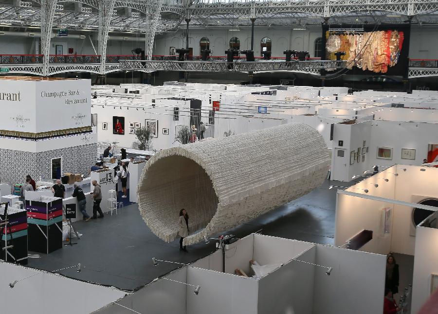 Monumental rice paper boat by renowned Chinese artist Zhu Jinshi is seen at the media preview of the Art 13 London new modern and contemporary art fair at Olympia Grand Hall in London, Feb. 28, 2013. The 12-metre-long installation made of 8,000 sheets of rice paper and presented by Pearl lam Galleries was built by 20 people over three days and brought to London from Shanghai. (Xinhua/Yin Gang)