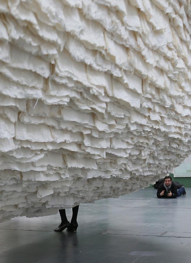 Monumental rice paper boat by renowned Chinese artist Zhu Jinshi is seen at the media preview of the Art 13 London new modern and contemporary art fair at Olympia Grand Hall in London, Feb. 28, 2013. The 12-metre-long installation made of 8,000 sheets of rice paper and presented by Pearl lam Galleries was built by 20 people over three days and brought to London from Shanghai. (Xinhua/Yin Gang)