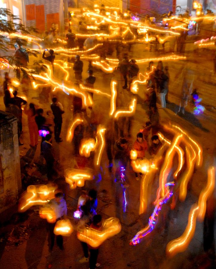 Residents attend an annual lantern parade in Nanshaxiang Village of Shantou, south China's Guangdong Province, Feb. 28, 2013. Participants of the festivity hold lanterns bearing their family names as they proceed through the village. They believe the village's lantern parade, which has existed for centuries, could bring good harvest and fortune. (Xinhua/Xu Ming)