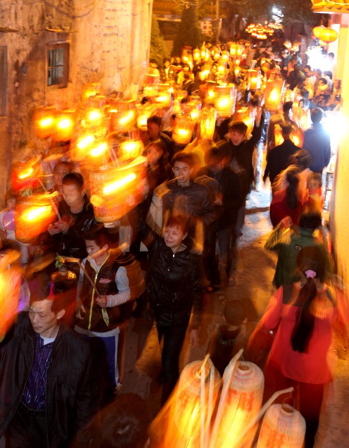 Residents attend an annual lantern parade in Nanshaxiang Village of Shantou, south China's Guangdong Province, Feb. 28, 2013. Participants of the festivity hold lanterns bearing their family names as they proceed through the village. They believe the village's lantern parade, which has existed for centuries, could bring good harvest and fortune. (Xinhua/Xu Ming)