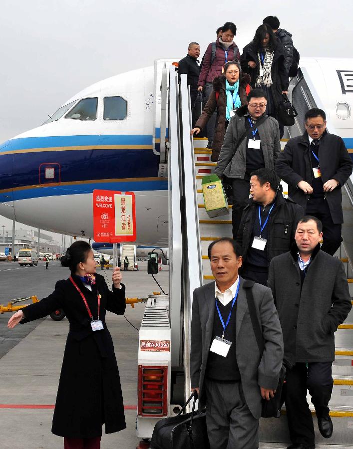 Deputies to the 12th National People's Congress (NPC) from northeast China's Heilongjiang Province arrive in Beijing, capital of China, March 2, 2013. The first session of the 12th NPC is scheduled to open in Beijing on March 5. (Xinhua/Wang Song)