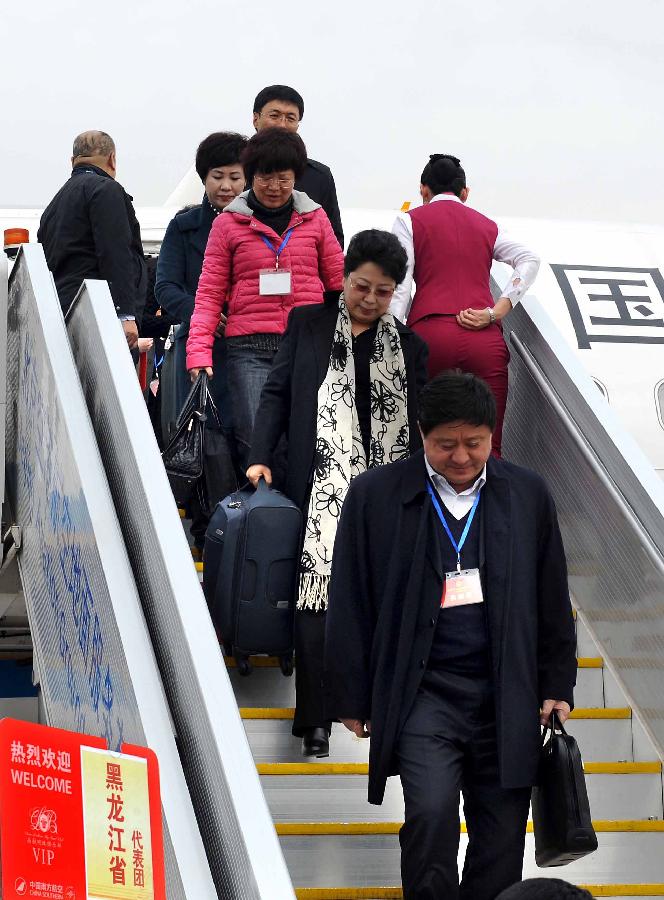 Deputies to the 12th National People's Congress (NPC) from northeast China's Heilongjiang Province arrive in Beijing, capital of China, March 2, 2013. The first session of the 12th NPC is scheduled to open in Beijing on March 5. (Xinhua/Wang Song)