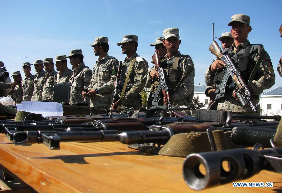 Afghan border police stand guard while Taliban's ammunition is presented to the media in Nangarhar province, eastern Afghanistan, on March 2, 2013. Afghan border police captured seven Taliban fighters with their ammunition during a operation in Nangarhar province on Saturday. (Xinhua/Tahir Safi) 