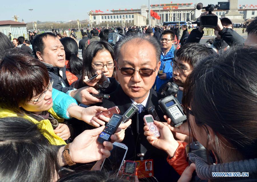 Wang Jie, a member of the 12th National Committee of the Chinese People's Political Consultative Conference (CPPCC),is interviewed at the Tian'anmen Square in Beijing, capital of China, March 3, 2013. The first session of the 12th CPPCC National Committee is to open on March 3. (Xinhua/Wang Song)