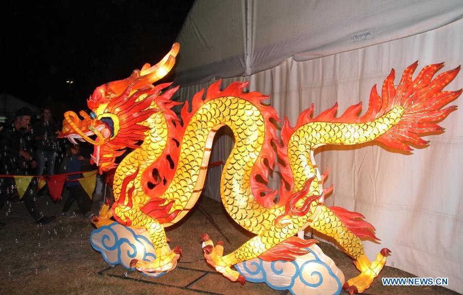 Residents watch the lanterns during the celebration of Chinese Lantern Festival in New Zealand's Christchurch, March 2, 2013. Ancient Chinese traditions mingled with contemporary folk-rock, acrobatics and kung fu tea-pouring as the 2013 Christchurch Lantern Festivals welcomed in the Year of the Snake on Saturday. (Xinhua/Huang Xingwei) 