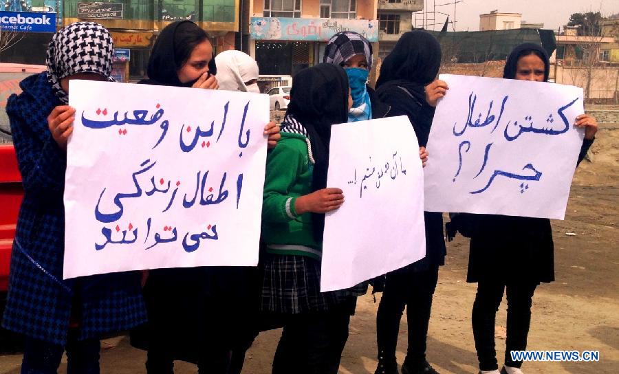 Afghan women carry slogans during a protest to condemn the killing of two children by NATO forces in Kabul, March 3, 2013. Two Afghan brothers, both under seven years old, were shot dead by a NATO helicopter after being mistaken for Taliban insurgents. (Xinhua/Omid)