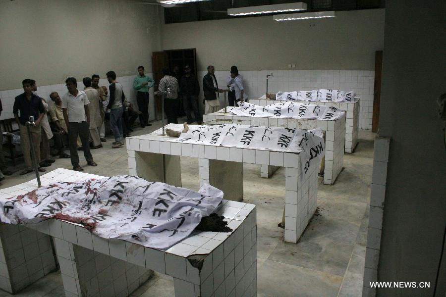 People gathered around bodies of blast victims at a hospital in southern Pakistani port city of Karachi on March 3, 2013. At least 40 people including women and kids were killed and over 135 others injured when twin blasts hit Pakistan's southern port city of Karachi on Sunday night, local officails said. (Xinhua/Arshad) 