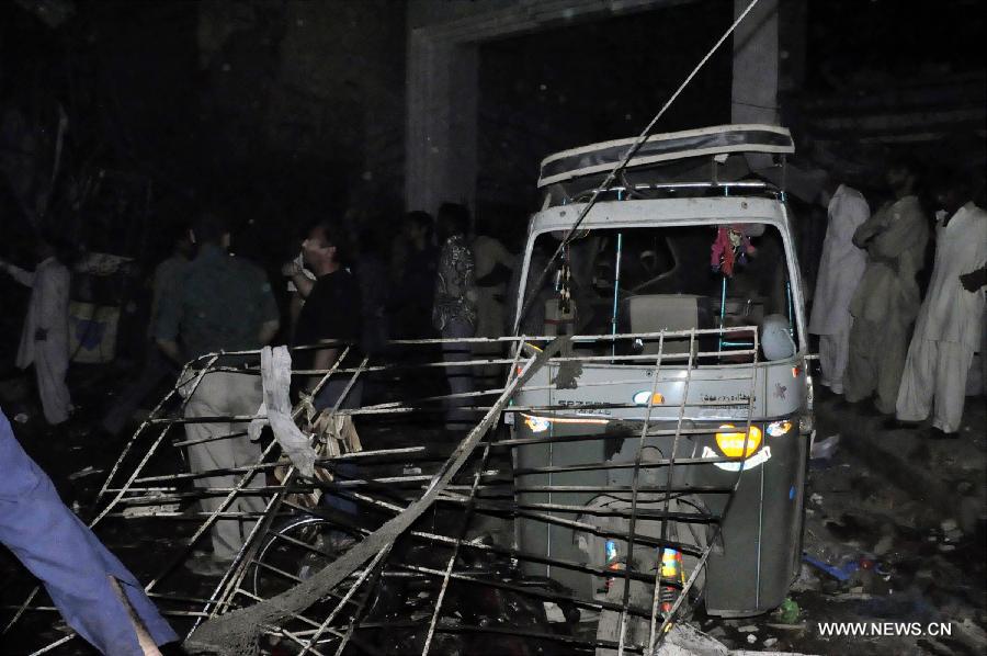 Residents gather at the twin blasts site in southern Pakistani port city of Karachi on March 3, 2013. At least 40 people were killed and over 135 others injured when twin blasts hit a residential area in Pakistan's southern port city of Karachi on Sunday night, local health official said. (Xinhua/Masroor) 