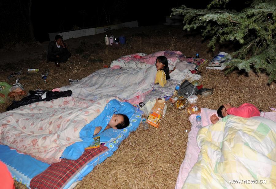 Children sleep at a campus after a 5.5-magnitude earthquake in Eryuan County of Dali Bai Autonomous Prefecture, southwest China's Yunnan Province, on March 3, 2013. The number of people confirmed injured by a 5.5-magnitude earthquake that hit southwest China's Yunnan Province on Sunday afternoon has risen to 30, local authorities have said. (Xinhua/Lin Yiguang) 