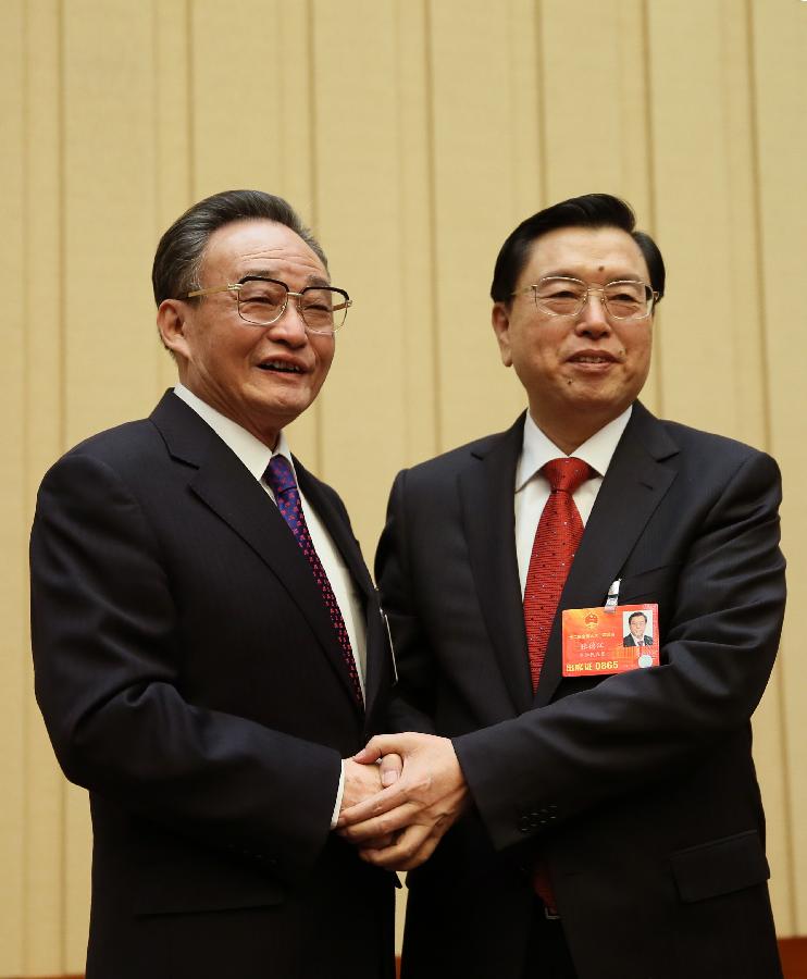 Wu Bangguo (L) shakes hands with Zhang Dejiang before the first meeting of the presidium of the first session of the 12th National People's Congress (NPC) at the Great Hall of the People in Beijing, capital of China, March 4, 2013. (Xinhua/Lan Hongguang)