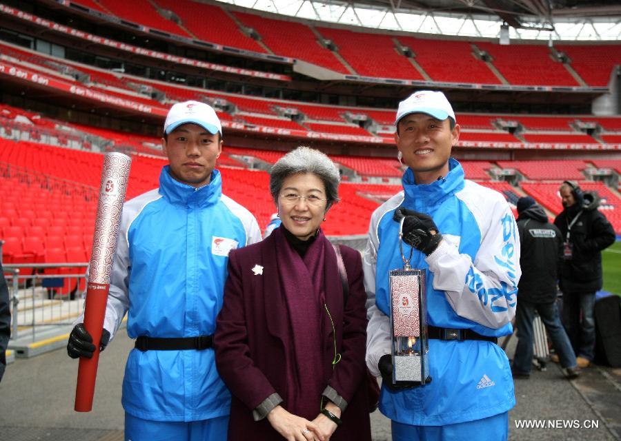 File photo taken on April 6, 2008 shows Fu Ying, Chinese Ambassador to the UK, poses for a photo with torchbearers of Beijing Olympics at Wembley Stadium in the UK. Fu Ying debuted at the Great Hall of the People as the spokesperson for the first session of the 12th National People's Congress (NPC) in Beijing, China, March 4, 2013. Born in 1953, the spokesperson was a diplomat of Mongolian ethnic group. Fu had respectively served as the Ambassador to the Philippines, Australia and the UK before she was appointed as Vice minister of Foreign Affairs in 2009. She became the 7th spokesperson of the NPC in March of 2013. (Xinhua)