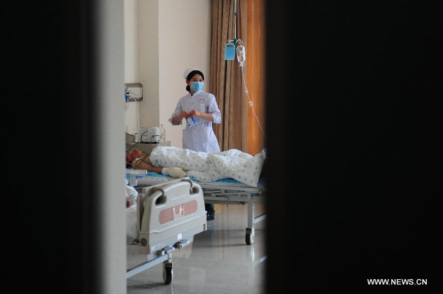 An injured man receives medical treatment in hospital after a gas explosion in an underground shopping street in Shenyang, capital of northeast China's Liaoning Province, March 4, 2013. More than 20 workers were injured in the explosion triggered by a gas leak from underground pipelines at a construction site in the underground shopping street in front of a shopping mall on Monday morning. Some 40 workers were at the scene at the time of the explosion. (Xinhua/Pan Yulong)  