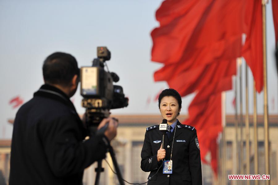 A journalist works at the Tian'anmen Square in Beijing, capital of China, March 5, 2013. The first session of the 12th National People's Congress (NPC) will open at the Great Hall of the People in Beijing on March 5. (Xinhua/Wang Peng)