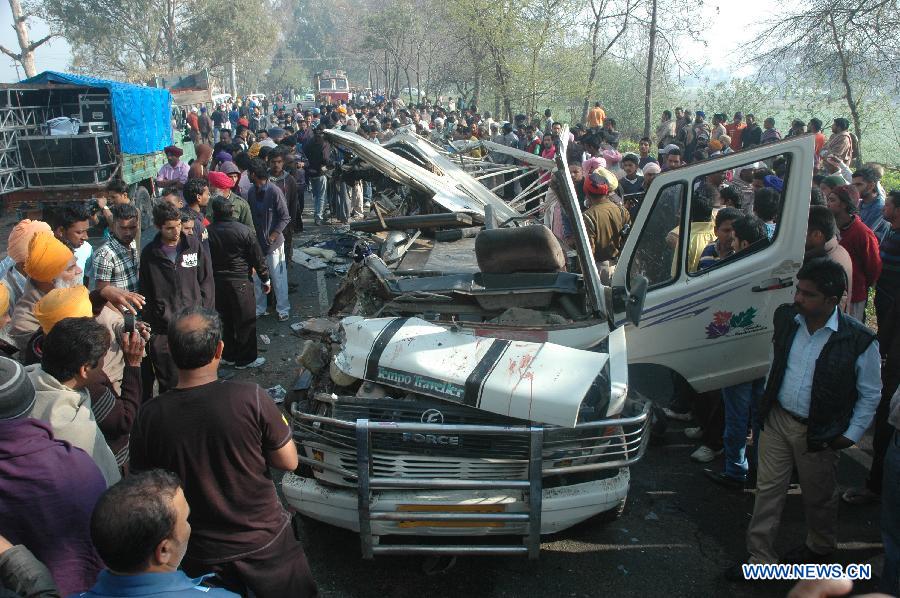 People gather around the ill-fated vehicle at Jalandhar district in the northern Indian state of Punjab, March 4, 2013. At least 11 children and their school bus driver were killed while 13 other students sustained injuries in a major road mishap in the northern Indian state of Punjab Monday, a senior police officer said. (Xinhua/Stringer) 