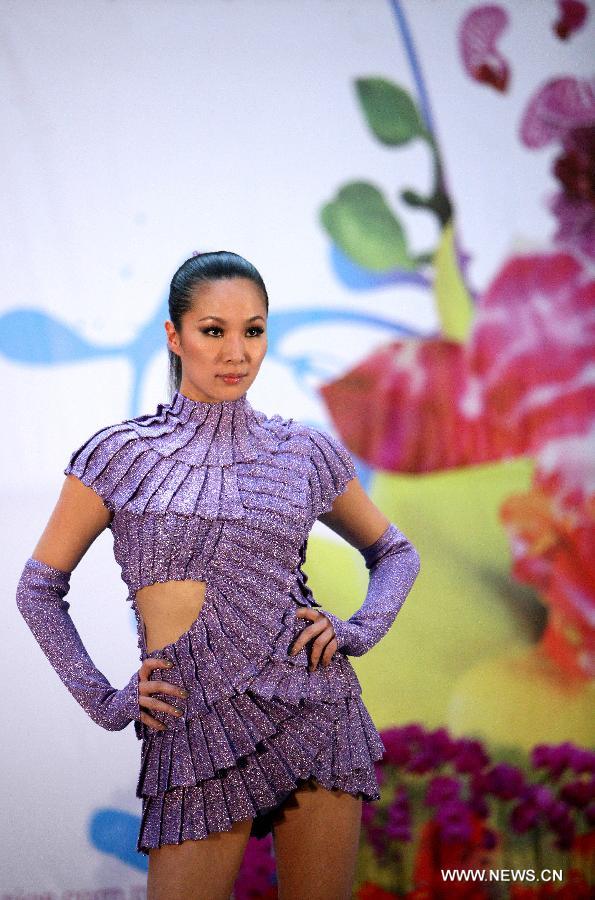 A model presents a creation themed with orchid during a press conference for the upcoming Orchid Show in Taipei, southeast China's Taiwan, March 4, 2013. The 2013 Taiwan International Orchid Show will be held in Tainan City from March 9 to 18. (Xinhua/Xie Xiudong)