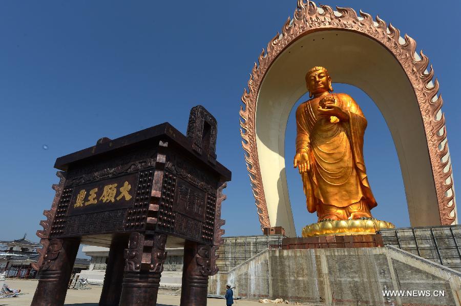 The Donglin Buddha statue is seen at the Donglin Temple in Xingzi County of Jiujiang City, east China's Jiangxi Province, March 6, 2013. The bronze statue of Amitabha Buddha, which is 48 meters in height, is believed to be the tallest of its kind in the world. The project, with the total cost of about 1 billion yuan (161 million U.S. dollars), has been basically completed. It was totally funded by private donations. (Xinhua/Song Zhenping)  