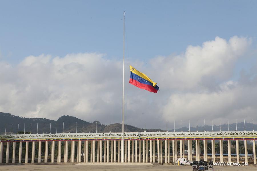 A national flag flies at half mast during the preparations for the funeral procession of Venezuelan President Hugo Chavez at Paseo Los Proceres in Caracas, capital of Venezuela, on March 6, 2013. On Tuesday afternoon, Venezuelan President, Hugo Chavez, died after fighting for almost two years with a cancer disease. The body of Chavez will be moved from the health center to the Military Academy in southern Caracas, inside Tiuna's Fort. (Xinhua/AVN)