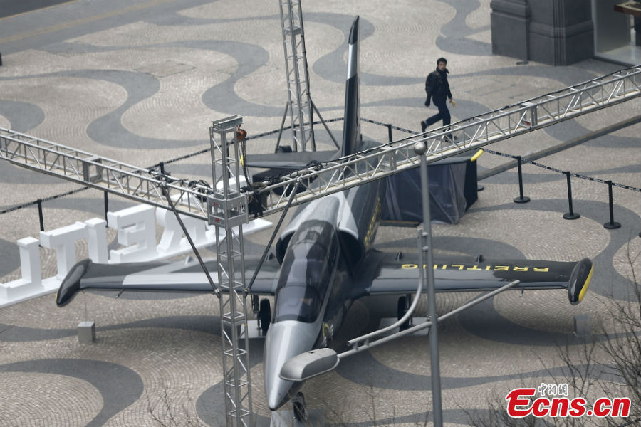 A full-size fighter jet model is put on display to mark the opening of a watch store at the Wangfujing Street in Beijing, March 6, 2013. (CNS/Fu Tian)