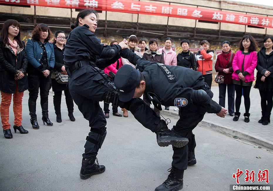 Members of Special Police unit of Huaibei Public Security Bureau in eastern China’s Anhui province demonstrate self-defense skills for local female workers with the hope of improving their awareness and ability of self-protection, March 6, 2013. (Chinanews.com/Han Suyuan) 