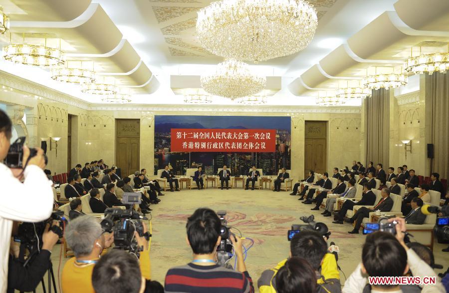 Zhang Dejiang, a member of the Standing Committee of the Political Bureau of the Communist Party of China (CPC) Central Committee, joins a discussion with deputies from south China's Hong Kong Special Administrative Region, who attend the first session of the 12th National People's Congress (NPC), in Beijing, capital of China, March 7, 2013. (Xinhua/Huang Jingwen)