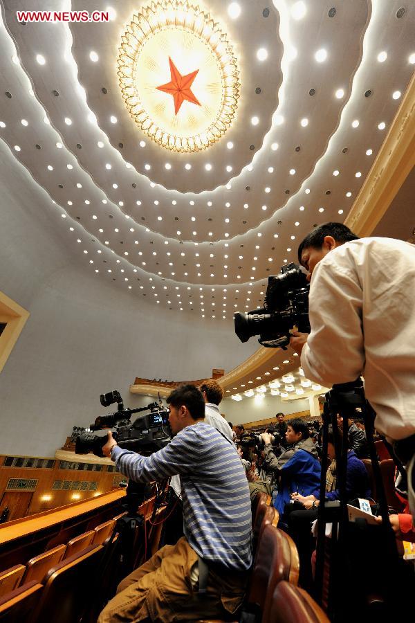Journalists work to cover the second plenary meeting of the first session of the 12th National Committee of the Chinese People's Political Consultative Conference (CPPCC) at the Great Hall of the People in Beijing, capital of China, March 7, 2013. (Xinhua/He Junchang) 
