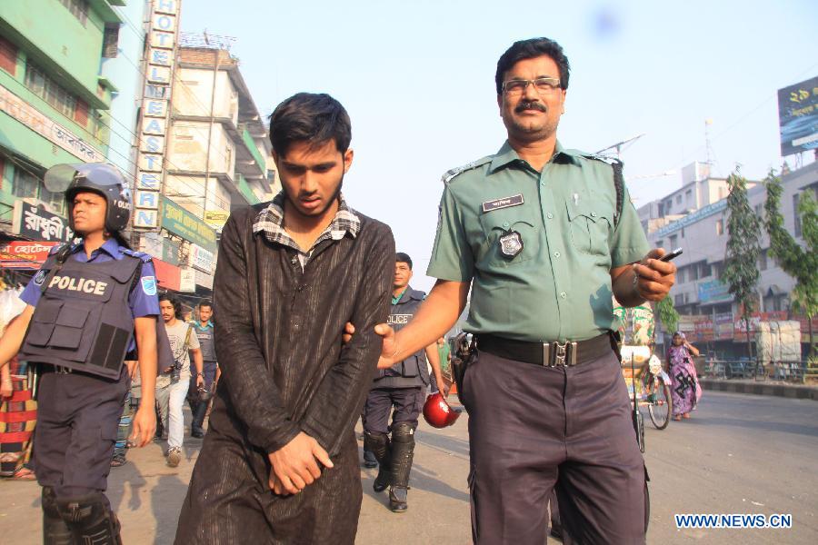 A policeman arrests an activist during a countrywide general strike in Dhaka, capital of Bangladesh, March 7, 2013. Bangladesh Nationalist Party (BNP) and its alliance called the daylong countrywide strike to protest after their previous rally fizzled out amidst clashes and bomb explosions.(Xinhua/Shariful Islam) 