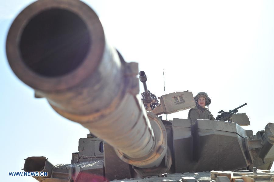 A female soldier of Israel Defense Forces (IDF)'s Shiryon (tank corps) unit takes part in a shooting training at Shizafon Armor Corps Training Base, south Israel, March 7, 2013 . These female soldiers will become instructors in Shiryon unit after finishing their 4-month training. (Xinhua/ Yin Dongxun) 