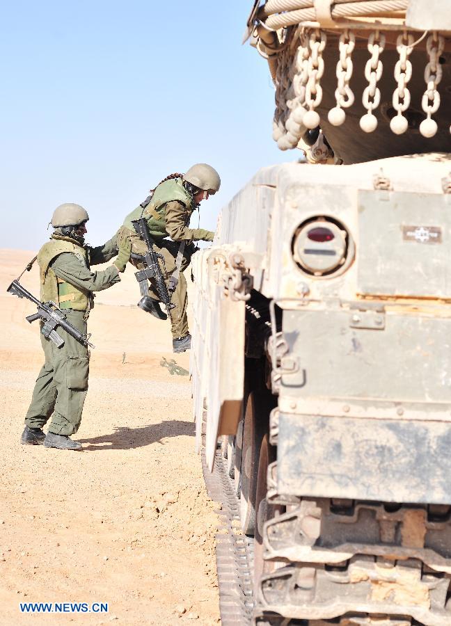 Female soldiers of Israel Defense Forces (IDF)'s Shiryon (tank corps) unit take part in a shooting training at Shizafon Armor Corps Training Base, south Israel, March 7, 2013. These female soldiers will become instructors in Shiryon unit after finishing their 4-month training. (Xinhua/ Yin Dongxun) 