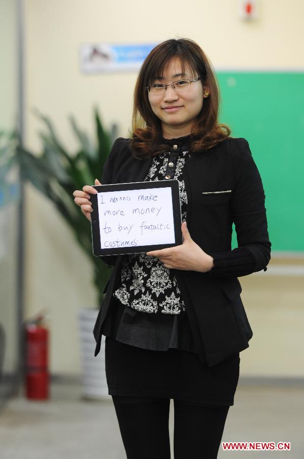 25-year-old Ms. Li, working at a language learning school, wishes for more salary to buy clothes for the Women's Day in Nanchang, capital of east China's Jiangxi Province, March 7, 2013. (Xinhua)