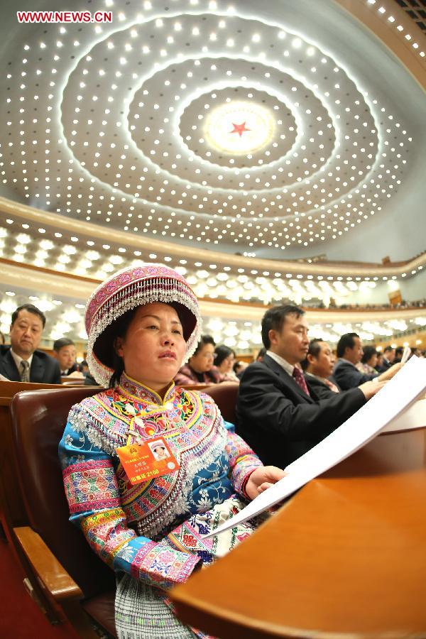 Wang Mingrong (L front), a deputy to the 12th National People's Congress (NPC), listens at the second plenary meeting of the first session of the 12th NPC in Beijing, capital of China, March 8, 2013. Women's presence in China's politics has been increasing in recent decades. The number of female deputies to the 12th National People's Congress and members of the 12th National Committee of the Chinese People's Political Consultative Conference (CPPCC) rise to 699 and 399, reaching 23.4% and 18.4% of the total respectively. (Xinhua/Chen Jianli) 