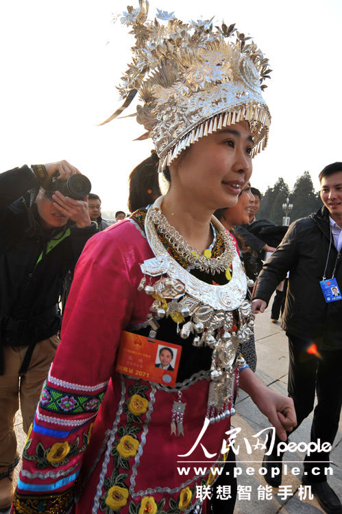 A female ethnic minority deputy wearing traditional ethnic minority costume during the opening meeting of the first session of the 12th National People's Congress (NPC) at the Great Hall of the People in Beijing, capital of China, March 5, 2013. (People’s Daily Online/Weng Qiyu)