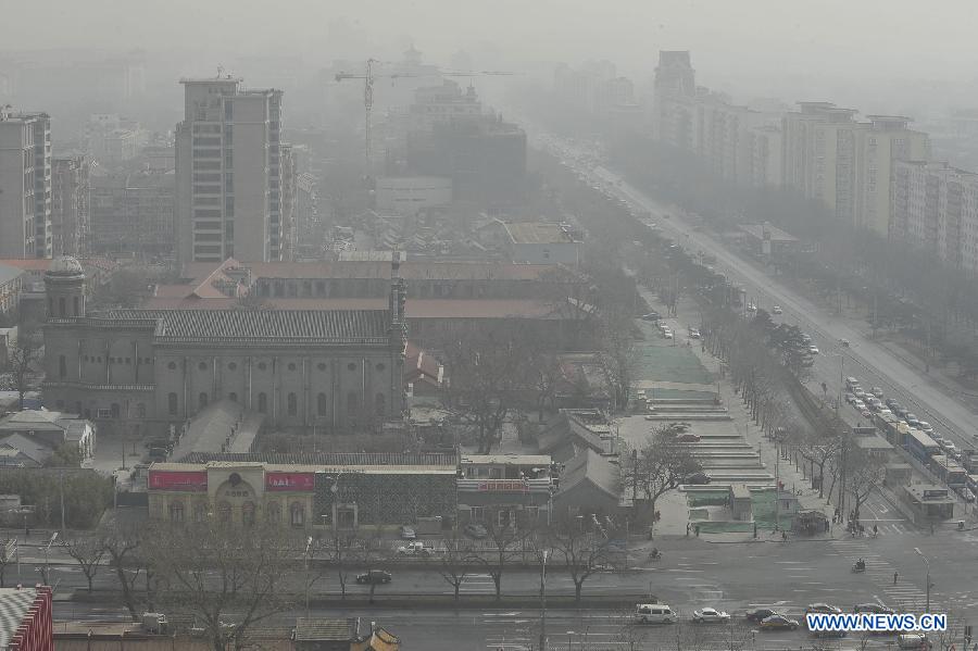 Sand and dust blanket buildings in Beijing, capital of China, March 9, 2013. A cold front brings strong wind as well as sand and dust to Beijing on March 9. (Xinhua/Lu Peng)