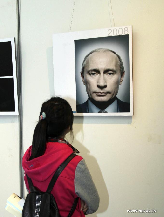 A girl visits a tour exhibition of the winning images of China International Press Photo Contest in the past years at the Wuxi Museum in Wuxi, east China's Jiangsu Province, March 9, 2013. (Xinhua/Sheng Guoping)