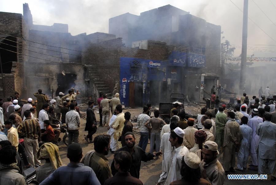 Pakistani demonstrators gather at a Christian neighborhood during a protest in Badami Bagh area of eastern Pakistan's Lahore on March 9, 2013. Hundreds of angry protestors on Saturday set ablaze more than 100 houses of Pakistani Christians over a blasphemy row in the eastern city of Lahore, local media reported. Over 3,000 Muslim protestors turned violent over derogatory remarks allegedly made by a young Christian against Prophet Mohammed in a Christian neighborhood in Badami Bagh area. (Xinhua Photo/Sajjad) 