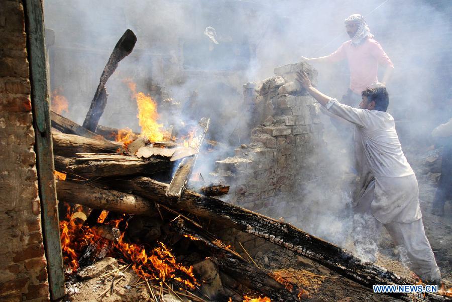 Pakistani demonstrators torch belongings of Christian families during a protest in a Christian neighborhood in Badami Bagh area of eastern Pakistan's Lahore on March 9, 2013. Hundreds of angry protestors on Saturday set ablaze more than 100 houses of Pakistani Christians over a blasphemy row in the eastern city of Lahore, local media reported. Over 3,000 Muslim protestors turned violent over derogatory remarks allegedly made by a young Christian against Prophet Mohammed in a Christian neighborhood in Badami Bagh area. (Xinhua Photo/Sajjad) 