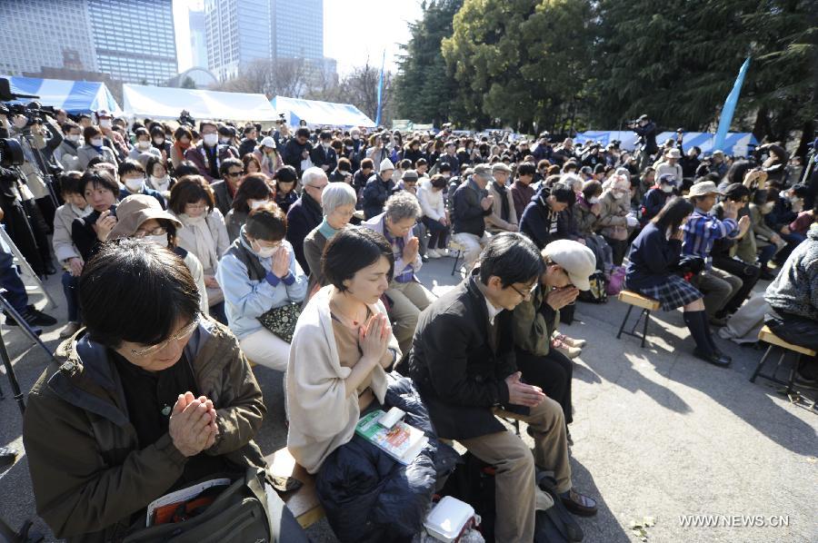  People attend a mourning ceremony in Tokyo, capital of Japan, on March 11, 2013. A mourning ceremony was held here Monday to mark the two year anniversary of the March 11 earthquke and ensuing tsunami that left more than 19,000 people dead or missing and triggered a nuclear accident the world had never seen since 1986. (Xinhua/Kenichiro Seki) 