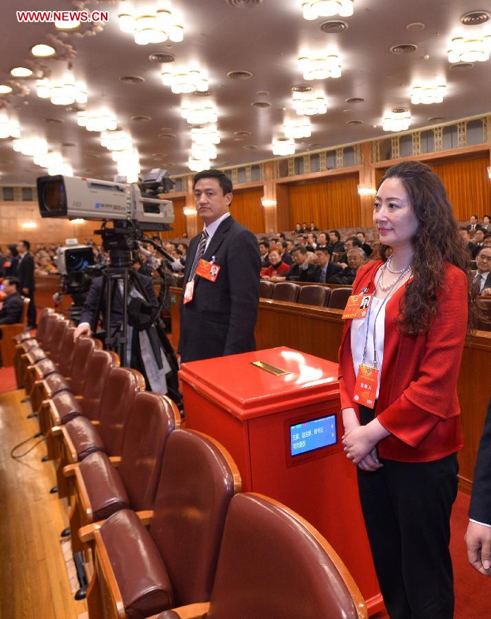 Members of the intendancy stand next to a ballot box at the fourth plenary meeting of the first session of the 12th National Committee of the Chinese People's Political Consultative Conference (CPPCC) held at the Great Hall of the People in Beijing, capital of China, March 11, 2013. Chairman, vice-chairpersons, secretary-general and Standing Committee members of the 12th CPPCC National Committee will be elected here on Monday afternoon. (Xinhua/Wang Ye) 